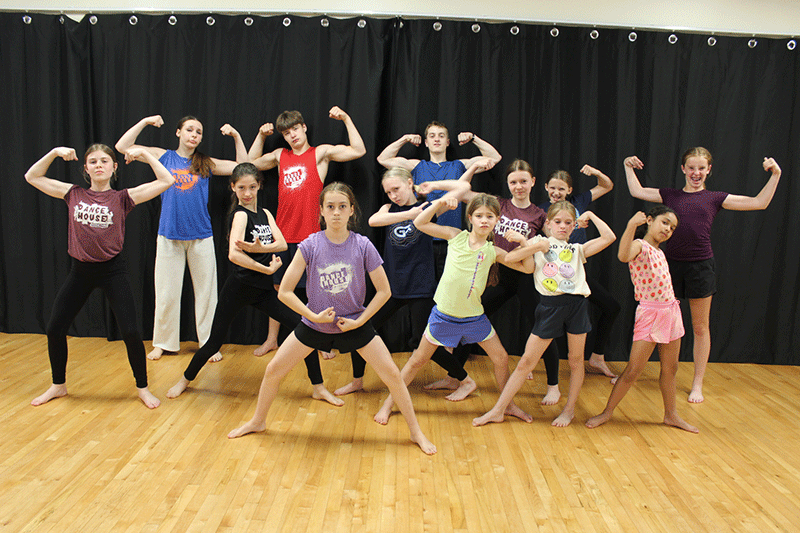Happy students in Dance Conditioning class flexing