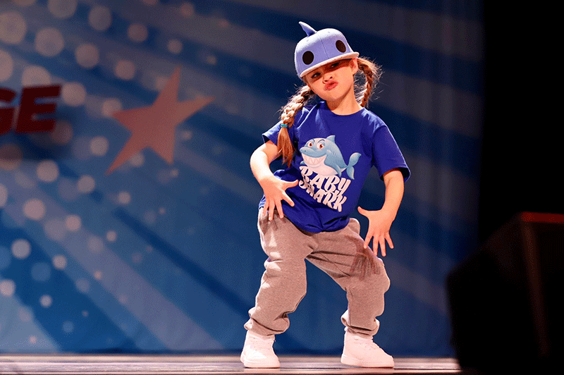 young female hip hop dancer posing on stage