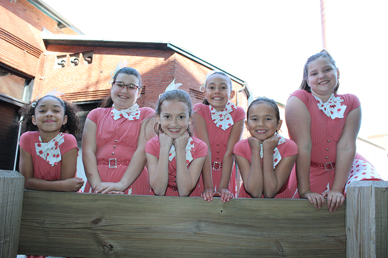 Jazz dance students posing in costume